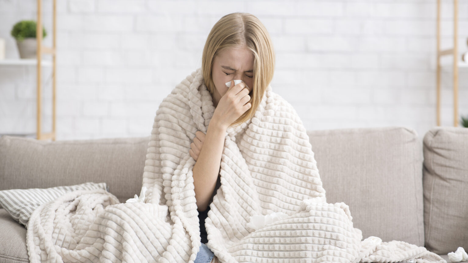 Young girl got sick, wrapped in blanket blowing nose - Wamberal Surgery